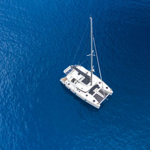 Aerial view of a catamaran yacht in the blue sea. Yachting, luxury vacation at sea. Yachting in the Caribbean