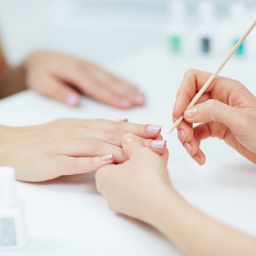 Woman hands receiving a manicure in beauty salon